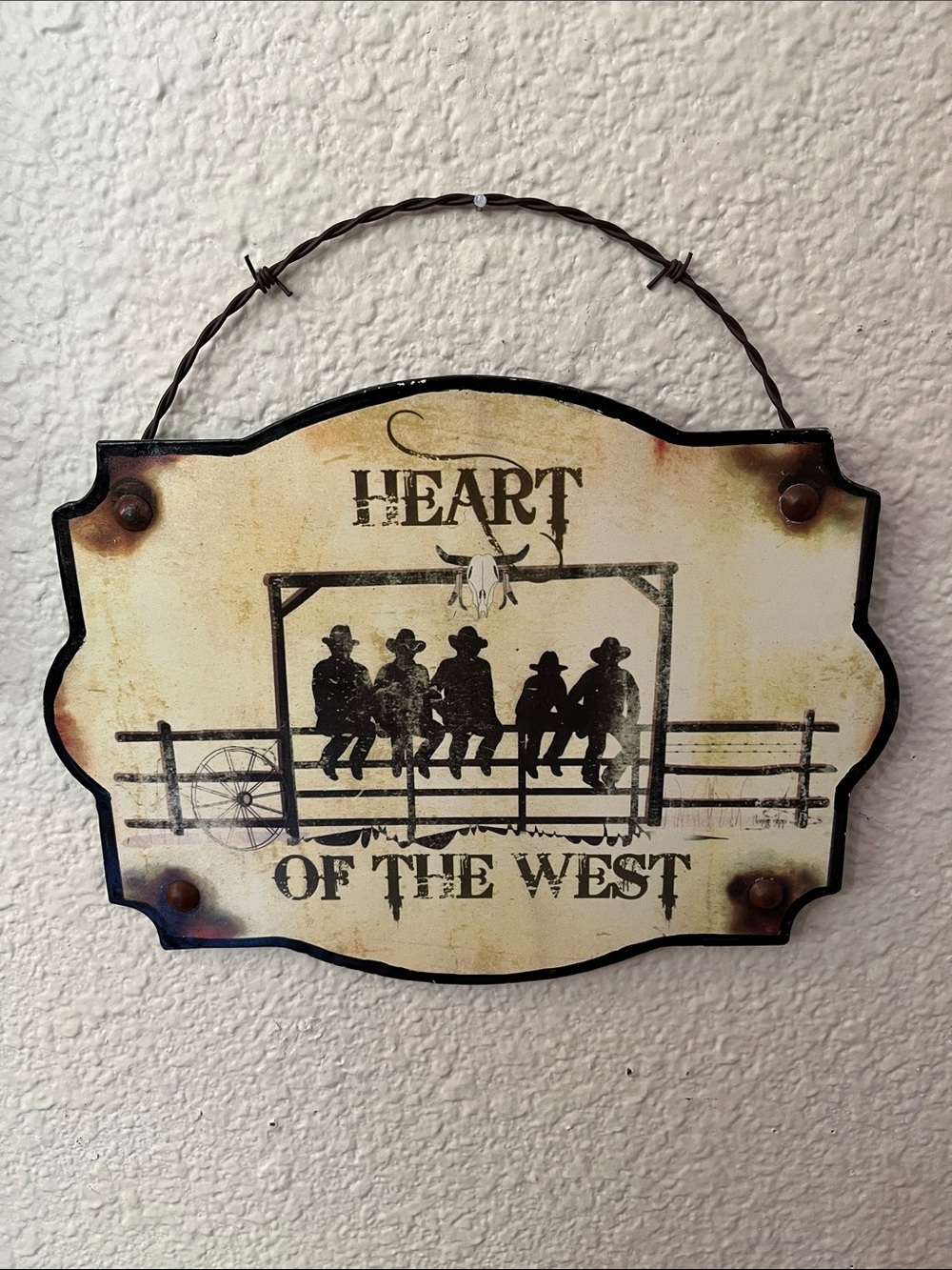 Rustic “Heart of the West" hanging metal wall sign